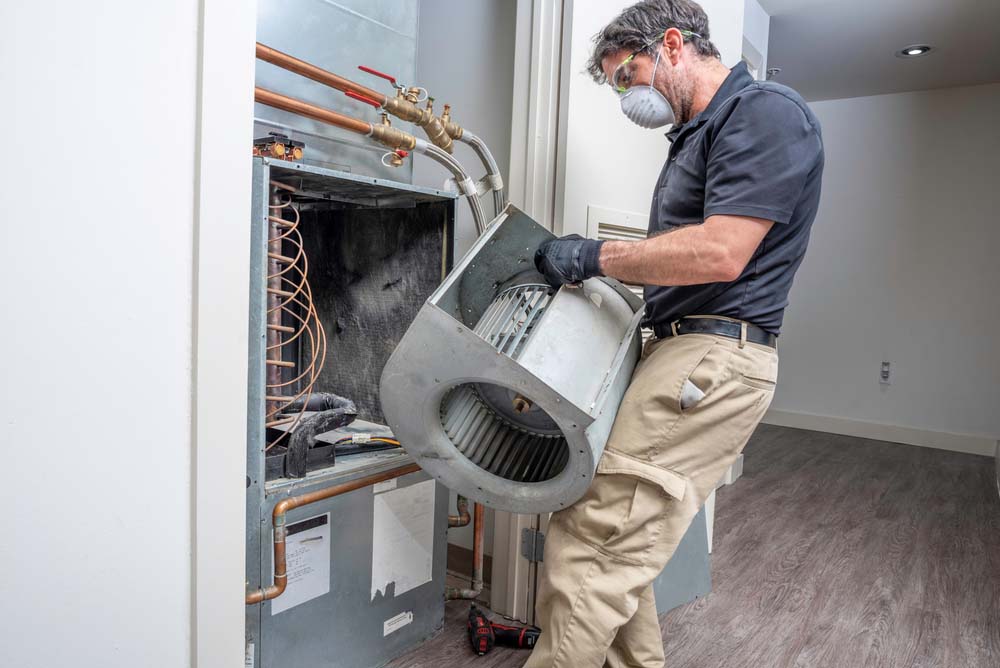 HVAC tech repairing a blower motor