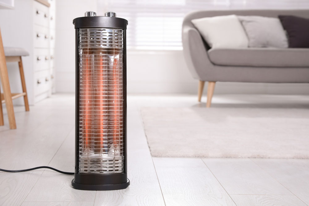 Modern electric heater on floor at home